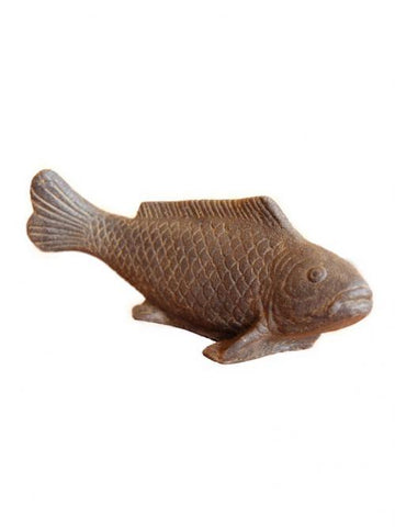 Decorative stone fish on a small pedestal